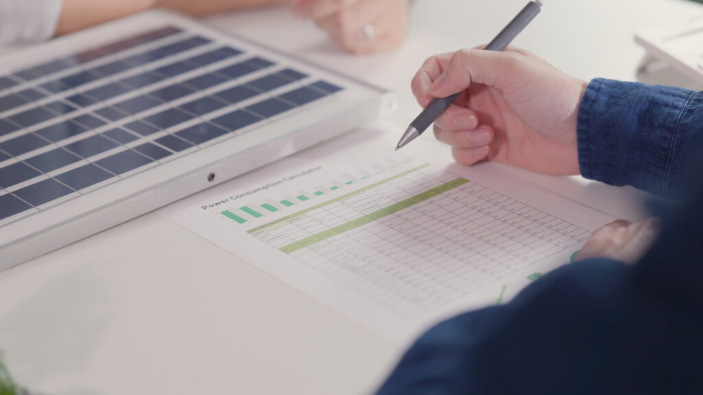 A close-up image of Solar Cancellation Resource Center professionals discussing and calculating homeowner's contract.