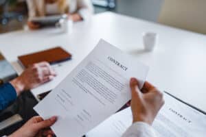 A Solar Cancellation Resource Center representative looking over a homeowners solar contract for misleading information.