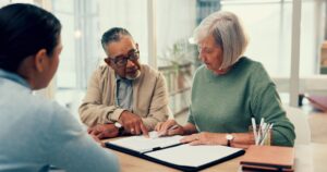 Homeowners looking over their contract with a specialist from Solar Cancellation Resource Center.