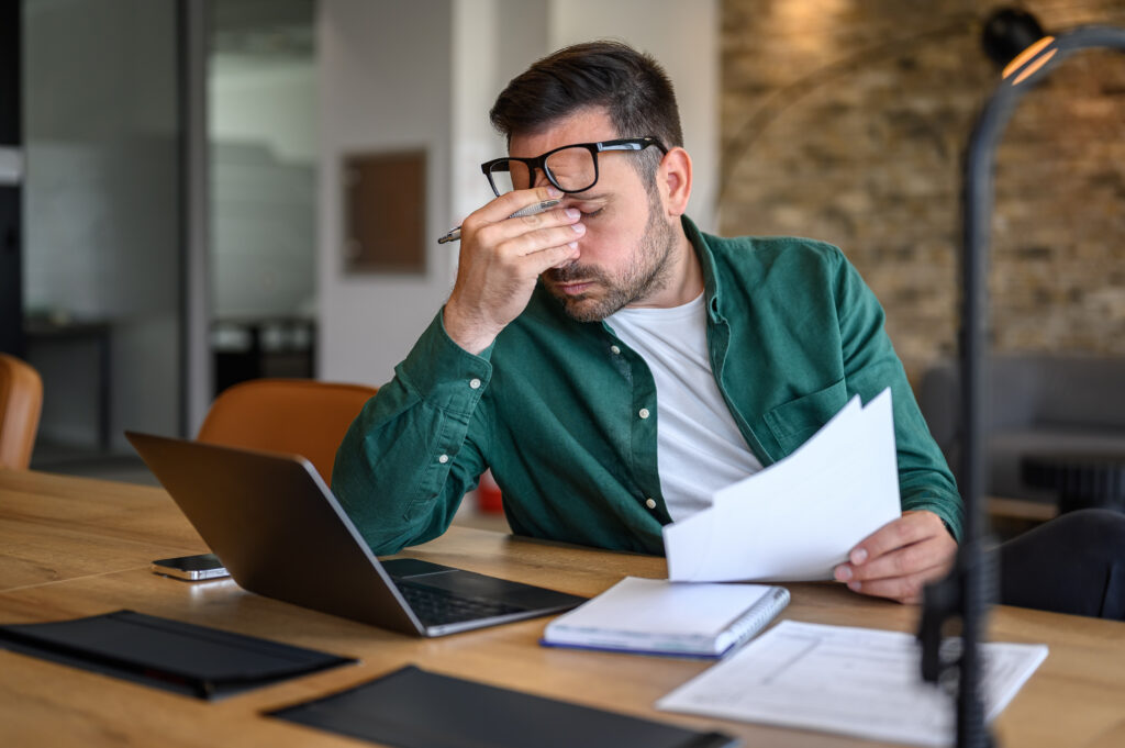 A homeowner looking over their solar contract and realizing they need to call Solar Cancellation Resource Center for help. 