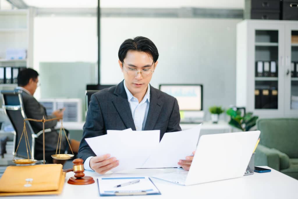 An intake specialist from Solar Cancellation Resource Center, looking over a clients documents to see if they qualify for cancellation.